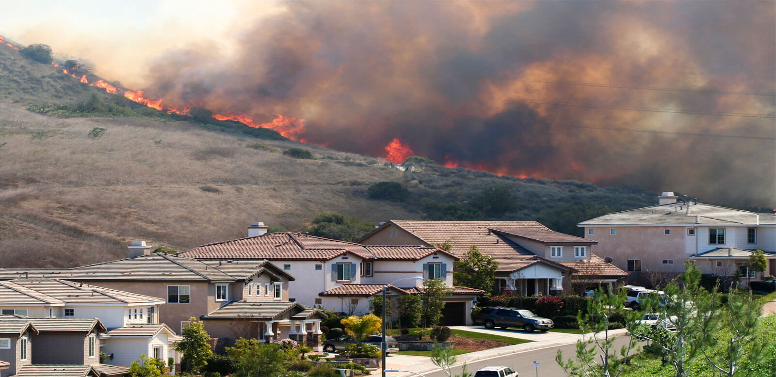 wildfire burning through neighborhood homes
