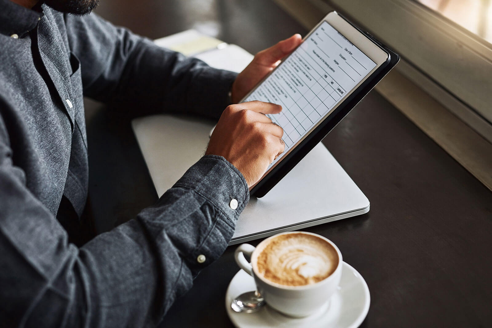 Man with digital tablet at coffee shop