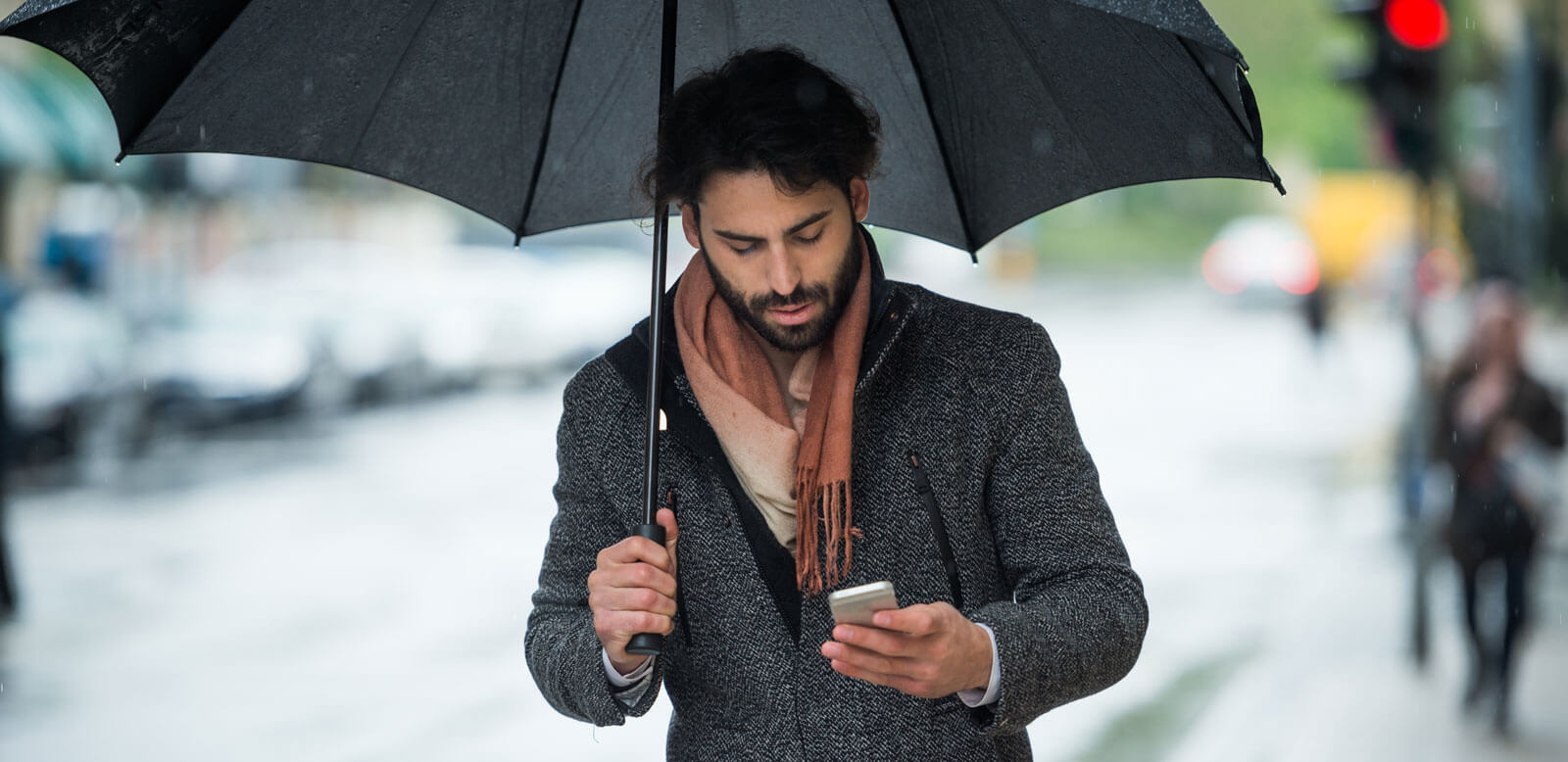 man with phone and umbrella