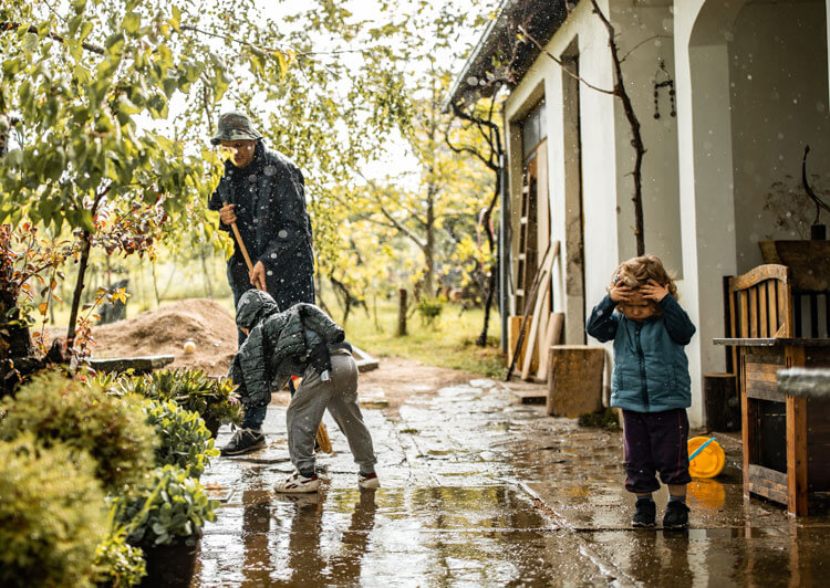 parent with kids in rain